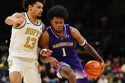Jan 19, 2023; Boulder, Colorado, USA; Washington Huskies forward Keion Brooks (1) drives at Colorado Buffaloes guard J'Vonne Hadley (13) in the second half at the CU Events Center. Mandatory Credit: Ron Chenoy-USA TODAY Sports