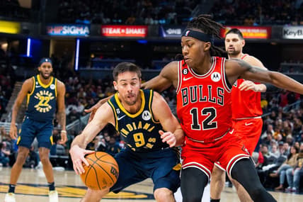Jan 24, 2023; Indianapolis, Indiana, USA; Indiana Pacers guard T.J. McConnell (9) dribbles the ball while Chicago Bulls guard Ayo Dosunmu (12) defends in the second quarter at Gainbridge Fieldhouse. Mandatory Credit: Trevor Ruszkowski-USA TODAY Sports