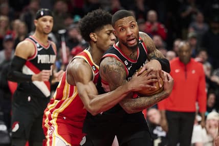 Jan 30, 2023; Portland, Oregon, USA; Atlanta Hawks forward De'Andre Hunter (12) fouls Portland Trail Blazers guard Damian Lillard (0) during the second half at Moda Center. Mandatory Credit: Troy Wayrynen-USA TODAY Sports