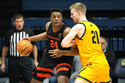 Jan 22, 2023; Berkeley, California, USA; Oregon State Beavers center KC Ibekwe (24) dribbles against California Golden Bears forward Lars Thiemann (21) during the second half at Haas Pavilion. Mandatory Credit: Darren Yamashita-USA TODAY Sports