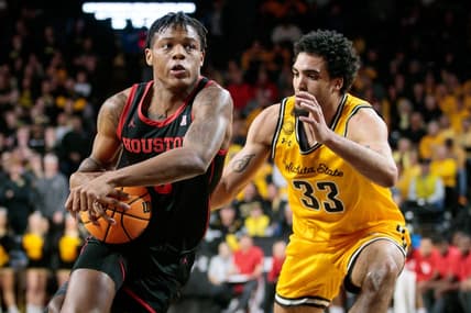 Jan 25, 2023; Wichita, Kansas, USA; Houston Cougars guard Marcus Sasser (0) drives around Wichita State Shockers forward James Rojas (33) during the first half at Charles Koch Arena. Mandatory Credit: William Purnell-USA TODAY Sports