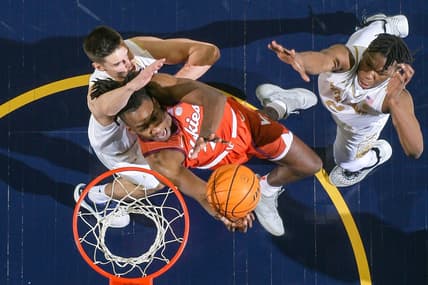 Feb 11, 2023; South Bend, Indiana, USA; Virginia Tech Hokies forward Justyn Mutts (25) goes up for a shot as Notre Dame Fighting Irish forward Nate Laszewski (14) defends in the first half at the Purcell Pavilion. Mandatory Credit: Matt Cashore-USA TODAY Sports