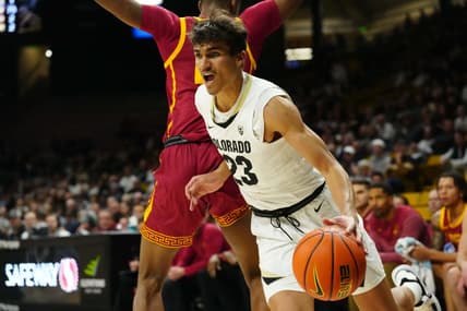 Feb 23, 2023; Boulder, Colorado, USA; Colorado Buffaloes forward Tristan da Silva (23) dribbles around USC Trojans forward Joshua Morgan (24) in the first half at the CU Events Center. Mandatory Credit: Ron Chenoy-USA TODAY Sports