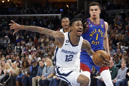 Feb 25, 2023; Memphis, Tennessee, USA; Memphis Grizzlies guard Ja Morant (12) drives to the basket as Denver Nuggets forward Michael Porter Jr. (1) defends during the second half at FedExForum. Mandatory Credit: Petre Thomas-USA TODAY Sports
