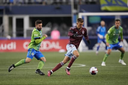 Feb 26, 2023; Seattle, Washington, USA; Colorado Rapids midfielder Cole Bassett (23) moves the ball defended by Seattle Sounders FC midfielder Joao Paulo (6) in the second half at Lumen Field. Mandatory Credit: Kirby Lee-USA TODAY Sports