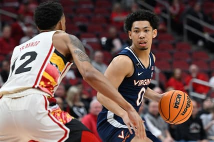 Feb 15, 2023; Louisville, Kentucky, USA;  Virginia Cavaliers guard Kihei Clark (0) dribbles against Louisville Cardinals forward JJ Traynor (12) during the first half at KFC Yum! Center. Virginia defeated Louisville 61-58. Mandatory Credit: Jamie Rhodes-USA TODAY Sports