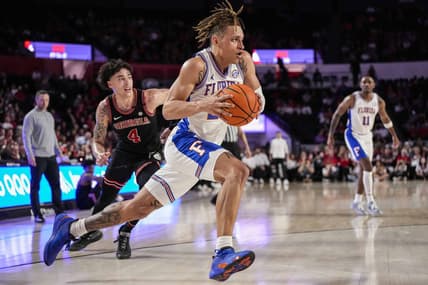 Feb 28, 2023; Athens, Georgia, USA; Florida Gators guard Riley Kugel (24) dribbles past Georgia Bulldogs guard Jusaun Holt (4) during the first half at Stegeman Coliseum. Mandatory Credit: Dale Zanine-USA TODAY Sports