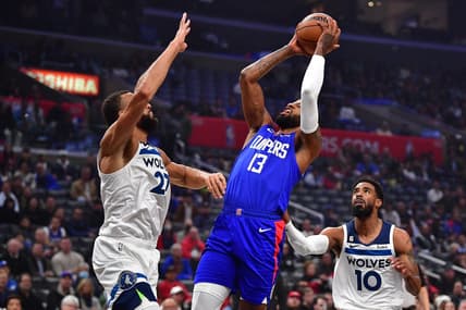 Feb 28, 2023; Los Angeles, California, USA; Los Angeles Clippers forward Paul George (13) shoots against Minnesota Timberwolves center Rudy Gobert (27) and guard Mike Conley (10) during the first half at Crypto.com Arena. Mandatory Credit: Gary A. Vasquez-USA TODAY Sports