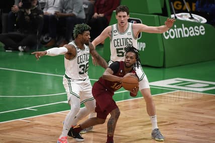 Mar 1, 2023; Boston, Massachusetts, USA;  Cleveland Cavaliers guard Darius Garland (10) controls the ball while Boston Celtics guard Marcus Smart (36) and forward Mike Mascala (57) defend during the first half at TD Garden. Mandatory Credit: Bob DeChiara-USA TODAY Sports