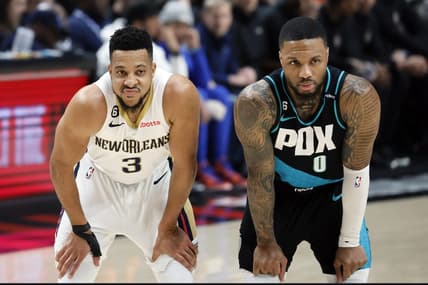 Mar 1, 2023; Portland, Oregon, USA; New Orleans Pelicans shooting guard CJ McCollum (3) and Portland Trail Blazers point guard Damian Lillard (0) look on during the first half at Moda Center. Mandatory Credit: Soobum Im-USA TODAY Sports