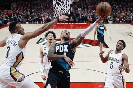 Mar 1, 2023; Portland, Oregon, USA; Portland Trail Blazers point guard Damian Lillard (0) shoots the ball against New Orleans Pelicans shooting guard CJ McCollum (3) during the first half at Moda Center. Mandatory Credit: Soobum Im-USA TODAY Sports