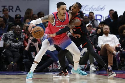 Mar 2, 2023; Washington, District of Columbia, USA; Washington Wizards forward Kyle Kuzma (33) drives to the basket as guard Will Barton (7) defends in the second quarter at Capital One Arena. Mandatory Credit: Geoff Burke-USA TODAY Sports