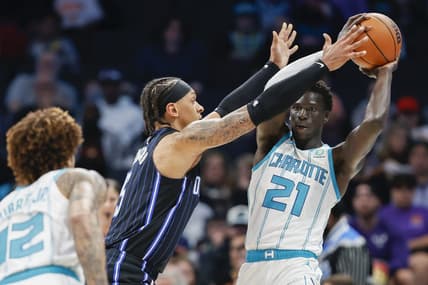 Mar 3, 2023; Charlotte, North Carolina, USA; Charlotte Hornets forward JT Thor (21) tries to pass against Orlando Magic forward Paolo Banchero (5) during the first half at Spectrum Center. Mandatory Credit: Nell Redmond-USA TODAY Sports