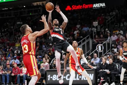 Mar 3, 2023; Atlanta, Georgia, USA; Portland Trail Blazers guard Damian Lillard (0) shoots over Atlanta Hawks guard Bogdan Bogdanovic (13) during the first half at State Farm Arena. Mandatory Credit: Dale Zanine-USA TODAY Sports