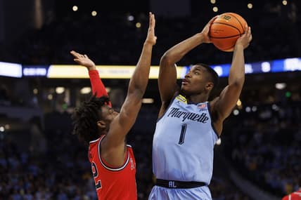 Mar 4, 2023; Milwaukee, Wisconsin, USA;  Marquette Golden Eagles guard Kam Jones (1) shoots against St. John   s Red Storm guard Kolby King (12) during the second half at Fiserv Forum. Mandatory Credit: Jeff Hanisch-USA TODAY Sports