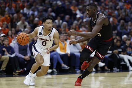 Mar 4, 2023; Charlottesville, Virginia, USA; Virginia Cavaliers guard Kihei Clark (0) drives to the basket as Louisville Cardinals forward Brandon Huntley-Hatfield (5) defends in the second half at John Paul Jones Arena. Mandatory Credit: Geoff Burke-USA TODAY Sports