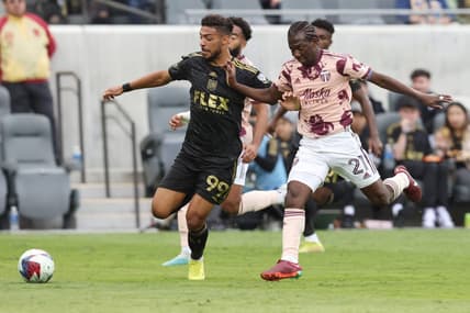 Mar 4, 2023; Los Angeles, California, USA; Los Angeles FC forward Denis Bouanga (99) dribbles against Portland Timbers midfielder Diego Chara (21) during the first half at BMO Stadium. Mandatory Credit: Jason Parkhurst-USA TODAY Sports