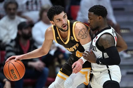 Mar 4, 2023; San Diego, California, USA; Wyoming Cowboys guard Hunter Maldonado (24) dribbles the ball while defended by San Diego State Aztecs guard Darrion Trammell (12) during the first half at Viejas Arena. Mandatory Credit: Orlando Ramirez-USA TODAY Sports