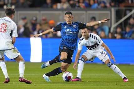 Mar 4, 2023; San Jose, California, USA; San Jose Earthquakes forward Cristian Espinoza (10) dribbles against Vancouver Whitecaps midfielder Alessandro Schopf (8) and defender Lu  s Martins (14) during the first half at PayPal Park. Mandatory Credit: Darren Yamashita-USA TODAY Sports