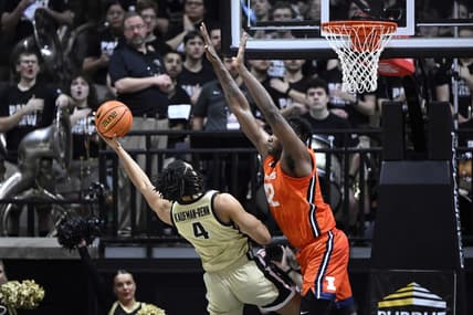 Mar 5, 2023; West Lafayette, Indiana, USA; Purdue Boilermakers forward Trey Kaufman-Renn (4) shoots the ball from under Illinois Fighting Illini forward Dain Dainja (42) during the first half at Mackey Arena. Mandatory Credit: Marc Lebryk-USA TODAY Sports