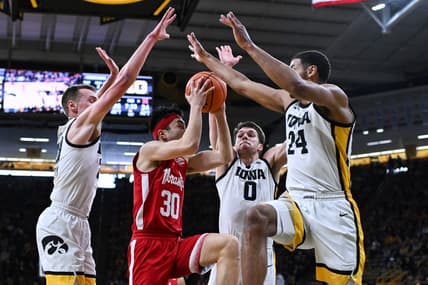 Mar 5, 2023; Iowa City, Iowa, USA; Nebraska Cornhuskers guard Keisei Tominaga (30) goes to the basket as Iowa Hawkeyes forward Kris Murray (24), forward Filip Rebraca (0) and forward Payton Sandfort (left) defend during the first half at Carver-Hawkeye Arena. Mandatory Credit: Jeffrey Becker-USA TODAY Sports