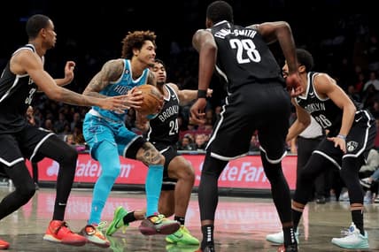 Mar 5, 2023; Brooklyn, New York, USA; Charlotte Hornets guard Kelly Oubre Jr. (12) drives to the basket against Brooklyn Nets center Nic Claxton (33) and guard Cam Thomas (24) and forward Dorian Finney-Smith (28) and guard Spencer Dinwiddie (26) during the second quarter at Barclays Center. Mandatory Credit: Brad Penner-USA TODAY Sports
