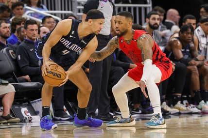 Mar 5, 2023; Orlando, Florida, USA; Portland Trail Blazers guard Damian Lillard (0) defends Orlando Magic guard Jalen Suggs (4) during the second quarter at Amway Center. Mandatory Credit: Mike Watters-USA TODAY Sports
