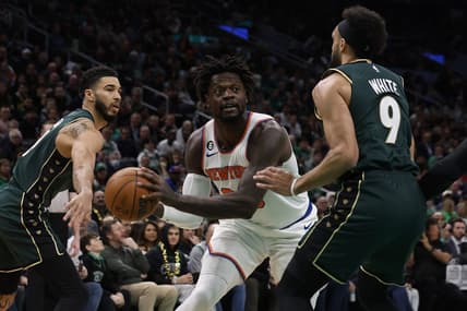 Mar 5, 2023; Boston, Massachusetts, USA; New York Knicks forward Julius Randle (30) looks for an opening between Boston Celtics guard Derrick White (9) and forward Jayson Tatum (0) during the first quarter at TD Garden. Mandatory Credit: Winslow Townson-USA TODAY Sports