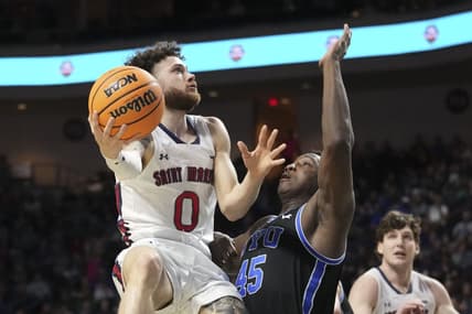 March 6, 2023; Las Vegas, NV, USA; Saint Mary's Gaels guard Logan Johnson (0) shoots the basketball against Brigham Young Cougars forward Fousseyni Traore (45) during the first half in the semifinals of the WCC Basketball Championships at Orleans Arena. Mandatory Credit: Kyle Terada-USA TODAY Sports