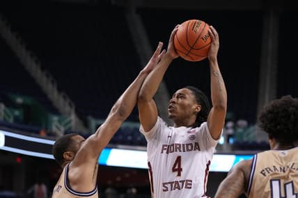 Mar 7, 2023; Greensboro, NC, USA; Florida State Seminoles guard Caleb Mills (4) shoots as Georgia Tech Yellow Jackets guard Kyle Sturdivant (1) and Georgia Tech Yellow Jackets forward Javon Franklin (4) defend in the second half of the first round of the ACC Tournament at Greensboro Coliseum. Mandatory Credit: Bob Donnan-USA TODAY Sports