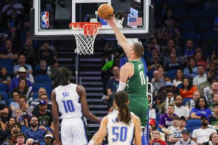 Mar 7, 2023; Orlando, Florida, USA; Milwaukee Bucks center Brook Lopez (11) goes to the basket against Orlando Magic center Bol Bol (10) during the second quarter at Amway Center. Mandatory Credit: Mike Watters-USA TODAY Sports