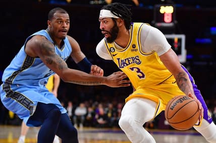 Mar 7, 2023; Los Angeles, California, USA; Los Angeles Lakers forward Anthony Davis (3) moves the ball against Memphis Grizzlies forward Xavier Tillman (2) during the first half at Crypto.com Arena. Mandatory Credit: Gary A. Vasquez-USA TODAY Sports