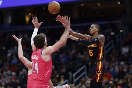 Mar 8, 2023; Washington, District of Columbia, USA; Atlanta Hawks guard Dejounte Murray (5) leaps to pass the ball over Washington Wizards forward Corey Kispert (24) in the first quarter at Capital One Arena. Mandatory Credit: Geoff Burke-USA TODAY Sports