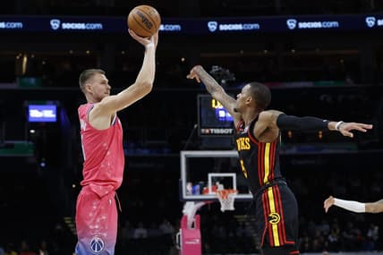 Mar 8, 2023; Washington, District of Columbia, USA; Washington Wizards center Kristaps Porzingis (6) shoots the ball as Atlanta Hawks guard Dejounte Murray (5) defends in the fourth quarter at Capital One Arena. Mandatory Credit: Geoff Burke-USA TODAY Sports