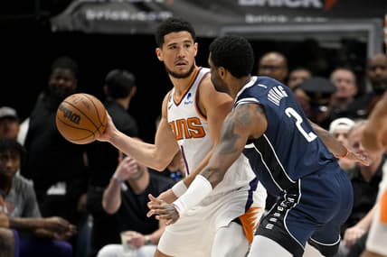 Mar 5, 2023; Dallas, Texas, USA; Phoenix Suns guard Devin Booker (1) and Dallas Mavericks guard Kyrie Irving (2) in action during the game between the Dallas Mavericks and the Phoenix Suns at the American Airlines Center. Mandatory Credit: Jerome Miron-USA TODAY Sports