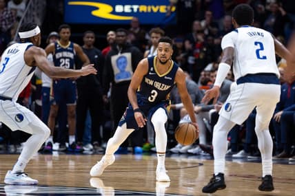 Mar 8, 2023; New Orleans, Louisiana, USA;  New Orleans Pelicans guard CJ McCollum (3) brings the ball up court against Dallas Mavericks guard Kyrie Irving (2) and guard Jaden Hardy (3) during the second half at Smoothie King Center. Mandatory Credit: Stephen Lew-USA TODAY Sports