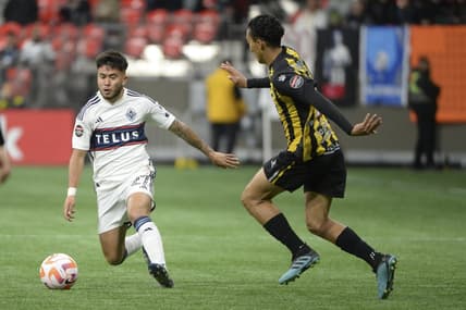 Mar 8, 2023; Vancouver, British Columbia, CAN;  Vancouver Whitecaps FC midfielder Ryan Raposo (27) chases a loose ball against Real Espana defender Carlos Mejia (28) during the first half at BC Place Stadium. Mandatory Credit: Anne-Marie Sorvin-USA TODAY Sports