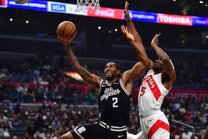 Mar 8, 2023; Los Angeles, California, USA; Los Angeles Clippers forward Kawhi Leonard (2) moves to the basket against Toronto Raptors forward Will Barton (5) during the first half at Crypto.com Arena. Mandatory Credit: Gary A. Vasquez-USA TODAY Sports