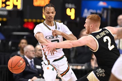 Mar 9, 2023; Greensboro, NC, USA; Miami (Fl) Hurricanes guard Isaiah Wong (2) passes the ball as Wake Forest Demon Deacons guard Cameron Hildreth (2) defends during the first half of the quarterfinals of the ACC tournament at Greensboro Coliseum. Mandatory Credit: Bob Donnan-USA TODAY Sports
