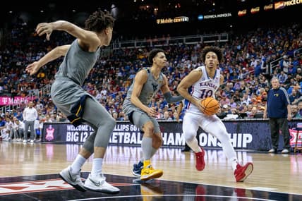 Mar 9, 2023; Kansas City, MO, USA; Kansas Jayhawks forward Jalen Wilson (10) moves to the basket around West Virginia Mountaineers forward Tre Mitchell (3) during the first half at T-Mobile Center. Mandatory Credit: William Purnell-USA TODAY Sports