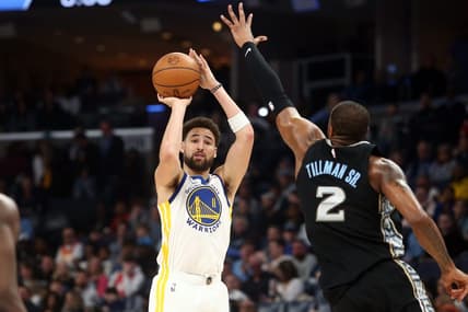 Mar 9, 2023; Memphis, Tennessee, USA; Golden State Warriors guard Klay Thompson (11) shoots for three as Memphis Grizzlies forward Xavier Tillman (2) defends during the first half at FedExForum. Mandatory Credit: Petre Thomas-USA TODAY Sports