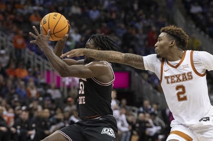 Mar 9, 2023; Kansas City, MO, USA; Oklahoma State Cowboys guard John-Michael Wright (51) handles the ball while defended by Texas Longhorns guard Arterio Morris (2) in the first half at T-Mobile Center. Mandatory Credit: Amy Kontras-USA TODAY Sports