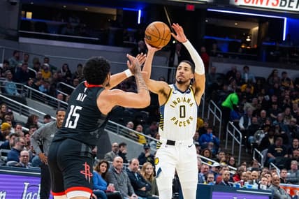 Mar 9, 2023; Indianapolis, Indiana, USA; Indiana Pacers guard Tyrese Haliburton (0) shoots the ball while Houston Rockets guard Daishen Nix (15) defends in the second quarter at Gainbridge Fieldhouse. Mandatory Credit: Trevor Ruszkowski-USA TODAY Sports