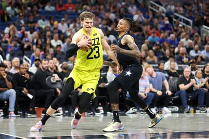 Mar 9, 2023; Orlando, Florida, USA;  Utah Jazz forward Lauri Markkanen (23) drives to the hope past Orlando Magic guard Markelle Fultz (20) in the fourth quarter at Amway Center. Mandatory Credit: Nathan Ray Seebeck-USA TODAY Sports