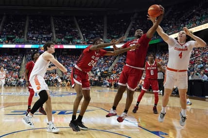 Mar 9, 2023; Greensboro, NC, USA; North Carolina State Wolfpack forward D.J. Burns Jr. (30) battles with Clemson Tigers forward Ian Schieffelin (4) for the ball during the first half of the quarterfinals of the ACC tournament at Greensboro Coliseum. Mandatory Credit: John David Mercer-USA TODAY Sports
