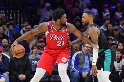 Mar 10, 2023; Philadelphia, Pennsylvania, USA; Philadelphia 76ers center Joel Embiid (21) is defended by Portland Trail Blazers guard Damian Lillard (0) during the first quarter at Wells Fargo Center. Mandatory Credit: Eric Hartline-USA TODAY Sports