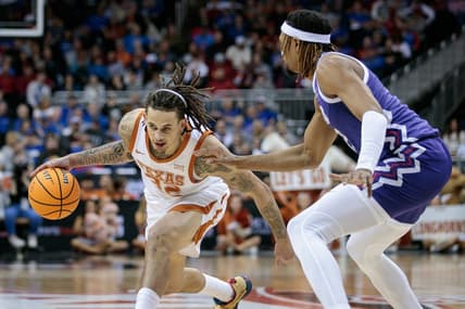 Mar 10, 2023; Kansas City, MO, USA; Texas Longhorns forward Christian Bishop (32) looks to drive around TCU Horned Frogs forward Xavier Cork (12) during the first half at T-Mobile Center. Mandatory Credit: William Purnell-USA TODAY Sports