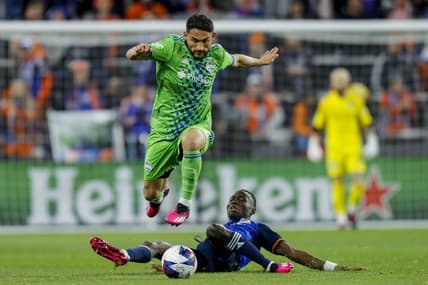Mar 11, 2023; Cincinnati, Ohio, USA; Seattle Sounders FC midfielder Cristian Roldan (7) dribbles against FC Cincinnati midfielder Obinna Nwobodo (5) in the first half at TQL Stadium. Mandatory Credit: Katie Stratman-USA TODAY Sports