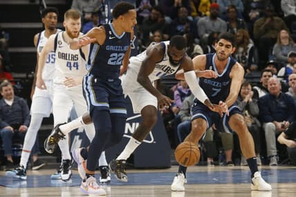 Mar 11, 2023; Memphis, Tennessee, USA; Dallas Mavericks forward Tim Hardaway Jr. (11) fights between Memphis Grizzlies guard Desmond Bane (22) and forward Santi Aldama (7) for a loose ball during the first half at FedExForum. Mandatory Credit: Petre Thomas-USA TODAY Sports