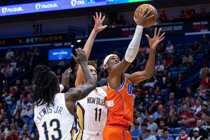Mar 11, 2023; New Orleans, Louisiana, USA; Oklahoma City Thunder guard Shai Gilgeous-Alexander (2) drives to the basket against New Orleans Pelicans guard Dyson Daniels (11) and guard Kira Lewis Jr. (13) during the first half at Smoothie King Center. Mandatory Credit: Stephen Lew-USA TODAY Sports